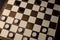 logical and educational checkers game for family and friends. white and black checkers on a brown board