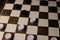 logical and educational checkers game for family and friends. white and black checkers on a brown board