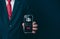 Login. A businessman\'s finger is holding a phone. Represents protection against external hacks.