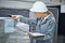 Logistics, clipboard and woman in warehouse with inventory for quality control and freight distribution. Hardhat