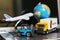 Logistics and supply chain management for online shopping concept: globe, white yellow truck, airplane, forklift on a laptop