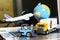 Logistics and supply chain management for online shopping concept: globe, white yellow truck, airplane, forklift on a laptop