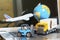 Logistics and supply chain management for online shopping concept: globe, white yellow truck, airplane, forklift on a laptop