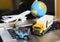 Logistics and supply chain management for online shopping concept: globe, white yellow truck, airplane, forklift on a laptop