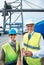 Logistics, supply chain and ship engineer or workers on the dock smiling while working in delivery industry. Cargo and