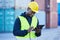 Logistics, tablet and black man doing container shipping at an industrial cargo, shipping and freight supply chain