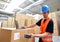 Logistics worker - man scans parcels of goods and prepares the d