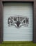 Logo for the Cowtown Marathon on a roll down garage door in the Foundry District`s Inspirational Alley in Fort Worth, Texas.