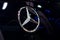 Logo of Merceds Benz on black car. Mercedes-Benz is a global automobile marque and a division of the German company Daimler AG