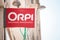 Logo of Orpi in front of their real estate broker in Lyon. Orpi is a cooperative network chain of real estate agents