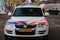 Logo of the police in the Netherlands named Politie with the blue and red striping on a police car.