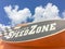 Logo of SpeedZone Dallas amusement center featuring go-kart raci