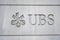 Logo of a Swiss bank UBS sculpted on the wall of building close up in city center of Zurich,.