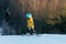 Logoisk. Belarus. 01.03.2023. A teenage snowboarder descends the slope of a snow-covered mountain in special equipment.