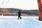 Logoisk. Belarus. 01.04.2023. A teenage snowboarder descends the slope of a snow-covered mountain in special equipment.