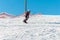 Logoisk. Belarus. 01.10.2023. A teenage snowboarder descends the slope of a snow-covered mountain
