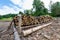 Logs in piles on the edge of the forest in the White Water Reserve in Pieniny