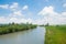 Loisach river with green riverbanks and cloudy sky