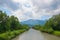 Loisach river with green riverbanks and cloudy sky