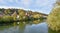 Loisach river Wolfratshausen, view to church and village, autumnal scenery bavaria