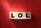 LOL sign. Wooden blocks on red. Laughing out loud.