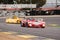 Lola T280 at the exit of a curve in a classic car race at the Jarama circuit chased by another yellow vehicle