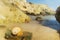 Lolantonis rocky beach at Paros island in Greece with a seashell at the foreground