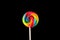 Lollipop, Big Round Rainbow colored lollipop isolated on dark pink black background