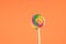 Lollipop, Big Round Rainbow colored lollipop isolated on Orange background,