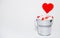 Lollipop heart shaped in Small bucket with sweets on white background