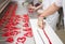 Lollipop making from melted sugar in traditional candy workshop