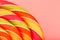 Lollipop multicolored close-up as background texture on pieces on pink background