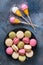 Lollipops and a full plate of macaroon on the table, top view