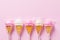 Lollipops on a stick in the form of ice cream on a pink background with a copy of space