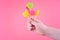 Lollipops of yellow, pink, green colors on wooden stick in the shape of circle, heart, flower.