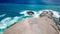 Lombok - Drone shot of a couple standing at the edge of a barren cliff