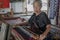 LOMBOK, INDONESIA : 16/09/2016 - Sasak lady traditionally makes yarn with a spindle wheel at traditional Sasak village, Desa Sasak