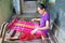 LOMBOK, INDONESIA - DECEMBER 30, 2016: Woman weaving on a loom