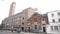 London, Britain-September, 2019: Old European houses with building with clock tower. Action. Street with people and