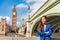 London business woman portrait. Urban city lifestyle. Asian businesswoman happy smiling looking towards Big Ben