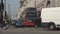 London downtown image with street traffic cars and red double decker buses
