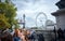 LONDON England - 08/21/2019: people leaving London`s Westminster underground station overlooking the ferris wheel