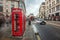 London, England - 15.03.2018: Iconic red telephone box near Piccadilly Circus with red double-decker bus