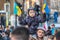 LONDON, ENGLAND- 26 February 2022: Child holding Ukranian flags outside Downing Street whilst protesting against Russia`s invasio