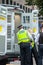 LONDON, ENGLAND- 30 August 2021: Extinction Rebellion protester being arrested after blocking Tower Bridge with a `lock-on` devi