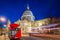 London, England - Beautiful Saint Paul`s Cathedral with traditional red double decker bus at night