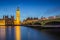 London, England - The Big Ben Clock Tower and Houses of Parliament with iconic red double-decker buses at city of westminster by