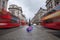 London, England - British umbrella at busy Regent Street with iconic red double-decker buses