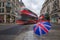 London, England - British umbrella at busy Regent Street with iconic red double-decker buses