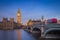 London, England - The iconic Big Ben with Houses of Parliament and traditional red double decker bus